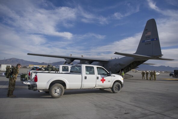 Capt. Steven Woods, 455th Expeditionary Aeromedical Evacuation Squadron flight nurse, deployed from the 43rd AES at Pope Army Airfield, N.C., gathers his gear before loading on to a C-130 Hercules for a medevac mission at Bagram Airfield, Afghanistan, Nov. 6, 2015. The 455th EAES is tasked with moving injured and sick patients to locations with higher levels of medical care. (U.S. Air Force photo by Tech. Sgt. Robert Cloys/RELEASED)