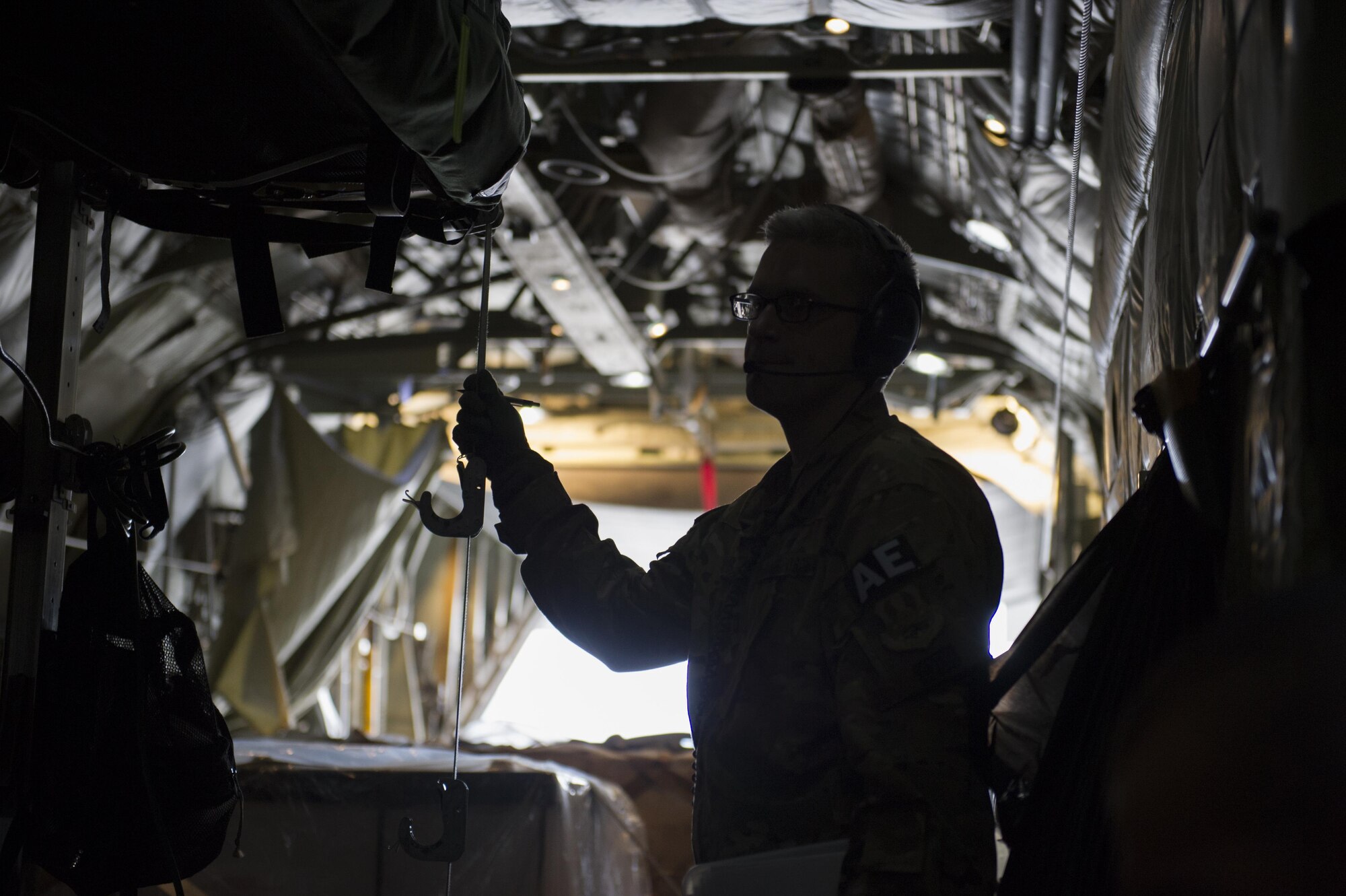 Capt. Steven Woods, 455th Expeditionary Aeromedical Evacuation Squadron flight nurse, deployed from the 43rd AES at Pope Army Airfield, N.C., checks the litter configuration aboard a C-130 Hercules during a medevac alert at Bagram Airfield, Afghanistan, Nov. 6, 2015. The 455th EAES is tasked with moving injured and sick patients to locations with higher levels of medical care. (U.S. Air Force photo by Tech. Sgt. Robert Cloys/RELEASED)