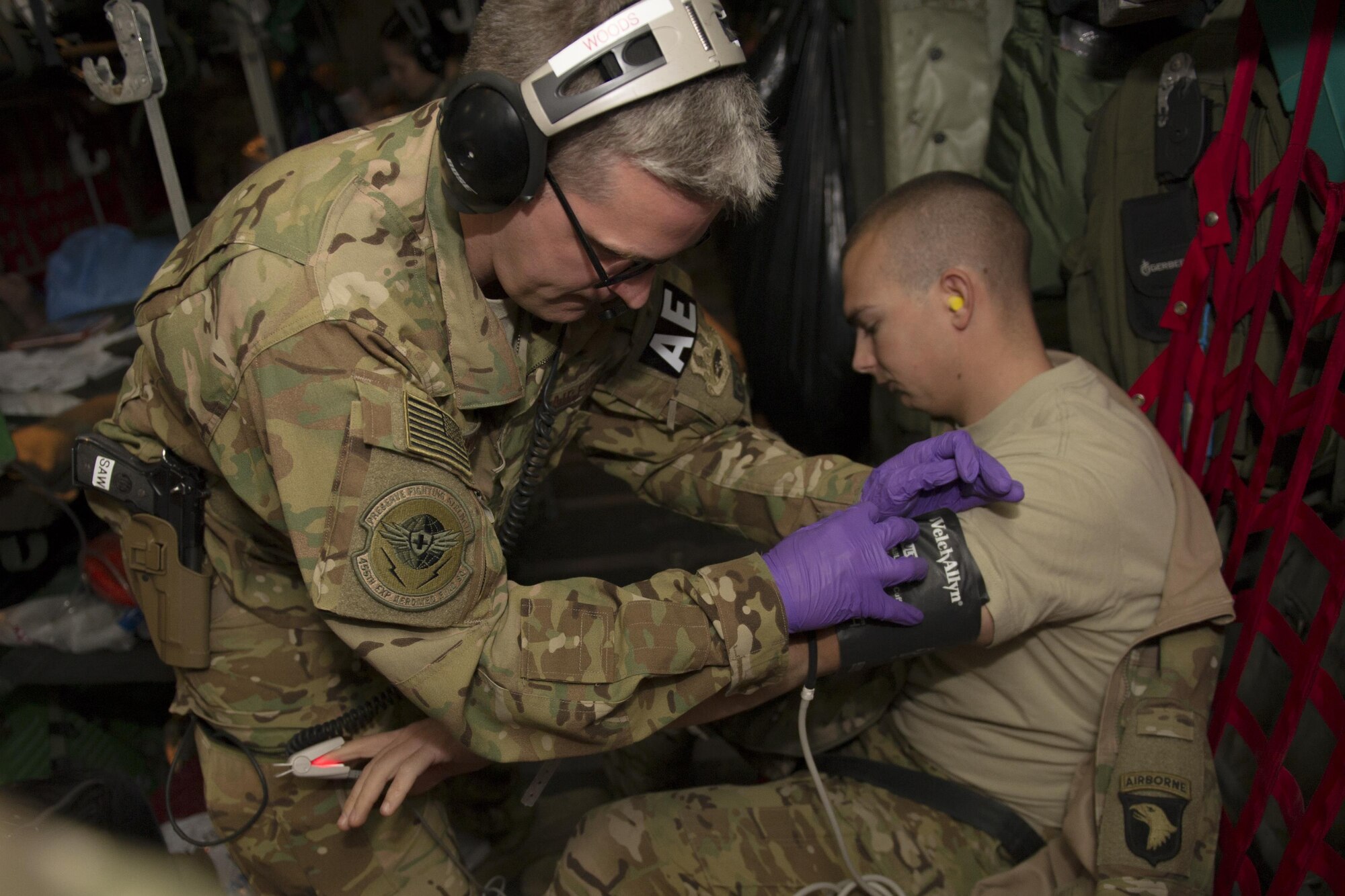 Capt. Steven Woods, 455th Expeditionary Aeromedical Evacuation Squadron flight nurse, deployed from the 43rd AES at Pope Army Airfield, N.C., checks the vitals of a patient during a medevac alert en route to Al Udeid Air Base, Qatar, from Bagram Airfield, Afghanistan, Nov. 6, 2015. The 455th EAES is tasked with moving injured and sick patients to locations with higher levels of medical care. (U.S. Air Force photo by Tech. Sgt. Robert Cloys/RELEASED)