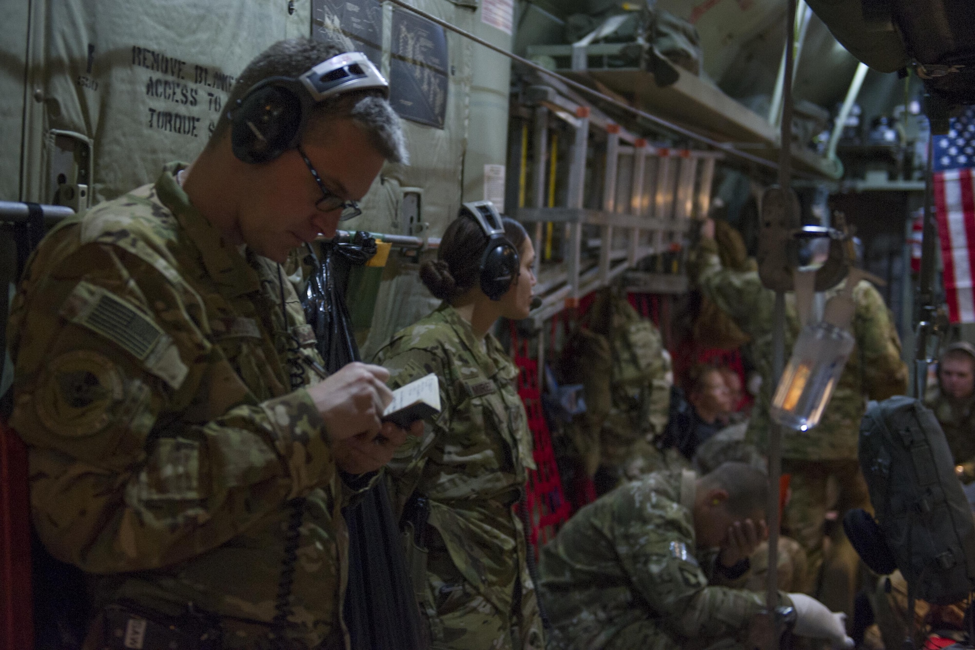 Capt. Steven Woods, 455th Expeditionary Aeromedical Evacuation Squadron flight nurse, deployed from the 43rd AES at Pope Army Airfield, N.C., records patient notes during a medevac alert in-route to Al Udeid Air Base, Qatar, from Bagram Airfield, Afghanistan, Nov. 6, 2015. The 455th EAES is tasked with moving injured and sick patients to locations with higher levels of medical care. (U.S. Air Force photo by Tech. Sgt. Robert Cloys/RELEASED)