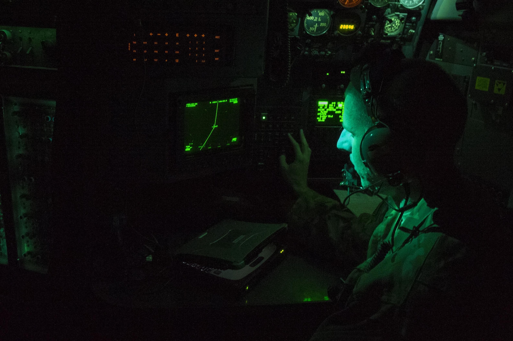 1st Lt. James Gillie, 746th Expeditionary Airlift Squadron flight navigator, deployed at Al Udeid Air Base, Qatar, monitors his equipment aboard a C-130 Hercules during an Aeromedical Evacuation flight from Bagram Airfield, Afghanistan to Al Udeid. The flight was in support of the 455th Expeditionary Evacuation Squadron, out of Bagram, who are tasked with moving injured and sick patients to locations with higher levels of medical care. (U.S. Air Force photo by Tech. Sgt. Robert Cloys/RELEASED)
