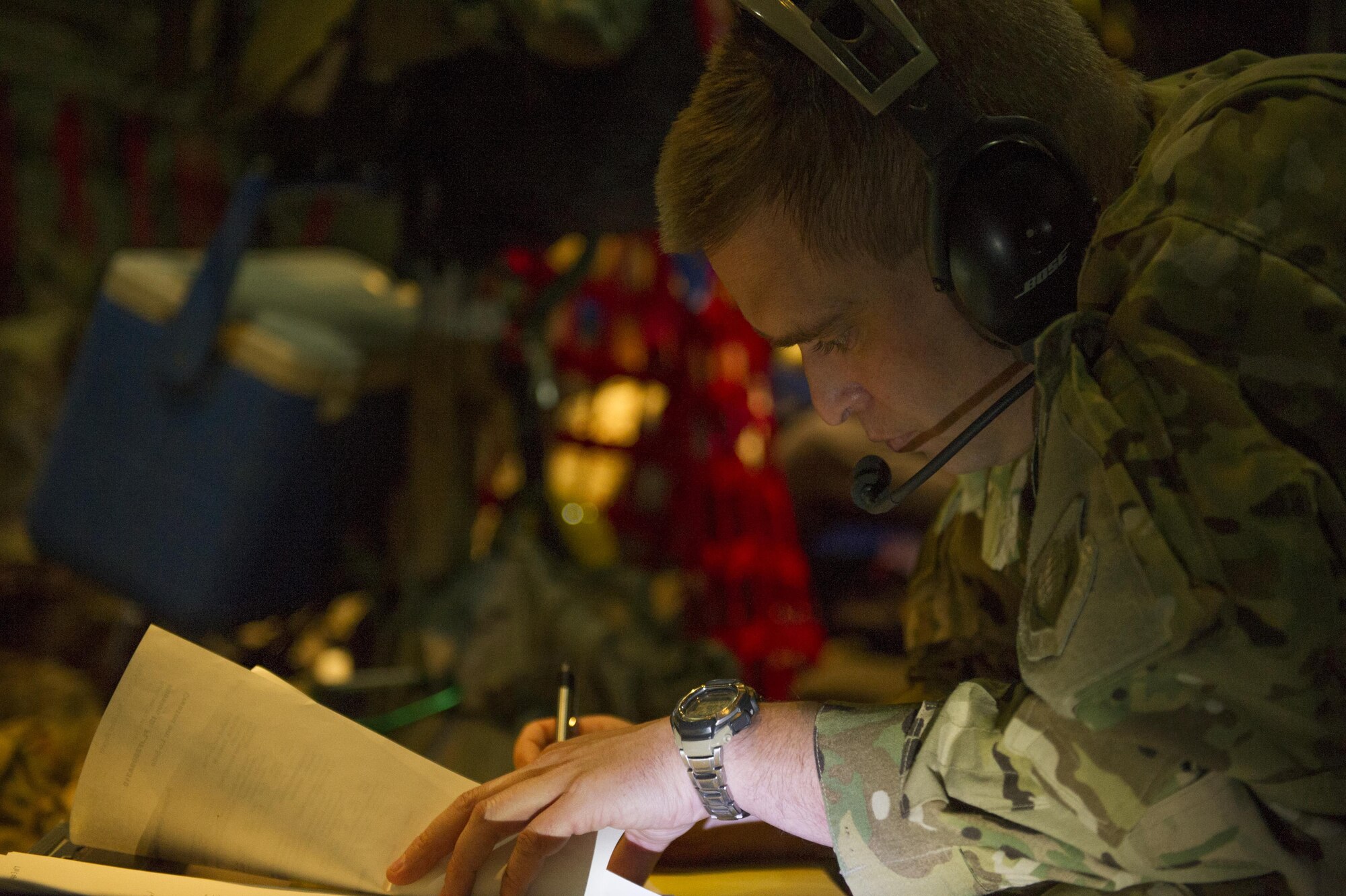 Maj. Jim Appel, 455th Expeditionary Aeromedical Evacuation Squadron flight nurse and medical crew director, deployed from the 18th AES at Kadena Air Base, Japan, fills out paperwork during a medevac alert en route to Al Udeid Air Base, Qatar, from Bagram Airfield, Afghanistan, Nov. 6, 2015. The 455th EAES is tasked with moving injured and sick patients to locations with higher levels of medical care. (U.S. Air Force photo by Tech. Sgt. Robert Cloys/RELEASED)