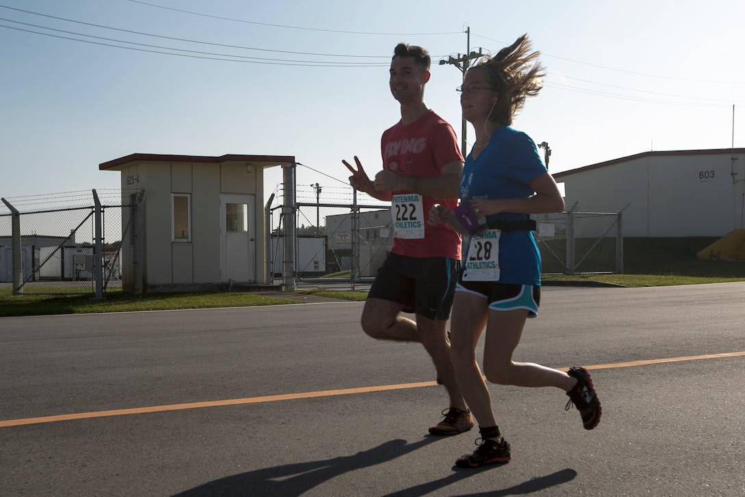 Mathew and Krystin Piston pose for a picture during the Habu Fun Run Oct. 26 on Marine Corps Air Station Futenma, Okinawa, Japan. Runners chose one of two paths at the beginning of their cardiovascular journey, either a five kilometer or 10 kilometer course. Mathew is a MV-22 Osprey Pilot with Marine Medium Tiltrotor Squadron 265, Marine Aircraft Group 36, 1st Marine Air Wing.
