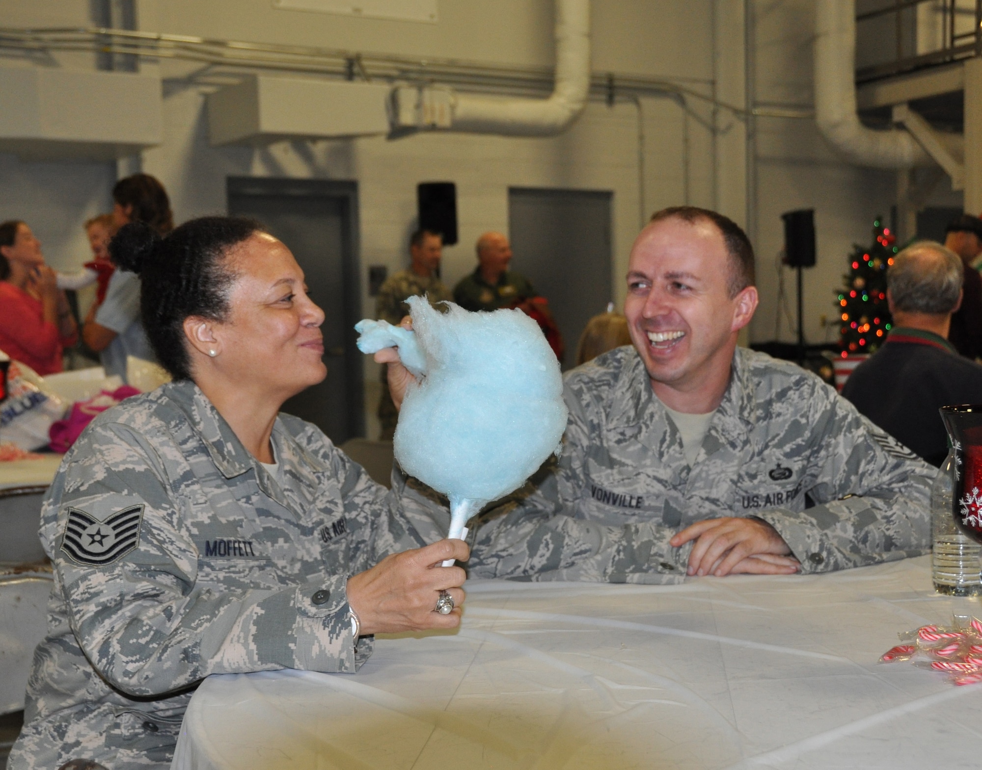 Tech. Sgts. Rhonda Moffett (left) and John Vonville, 512th Force Support Squadron's Airman and Family Readiness Flight, attend the 512th Airlift Wing Holiday Social Nov. 7, 2015, at Dover Air Force Base, Del. The annual wing-wide event offered an opportunity for reservists and their families to gather for fellowship and it featured photo opportunities with Santa aboard a C-17 Globemaster and C-5 Galaxy. (U.S. Air Force photo/Staff St. Joe Yanik)