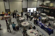 Reservists with the 512th Airlift Wing and their families gather at the 512th Airlift Control Flight's hangar for the wing's annual Holiday Social Nov. 7, 2015, at Dover Air Force Base, Del. The event offered an opportunity for reservists to fellowship with each other and learn about a variety of military services support, like Military One Source. (U.S. Air Force photo/Staff Sgt. Joe Yanik)