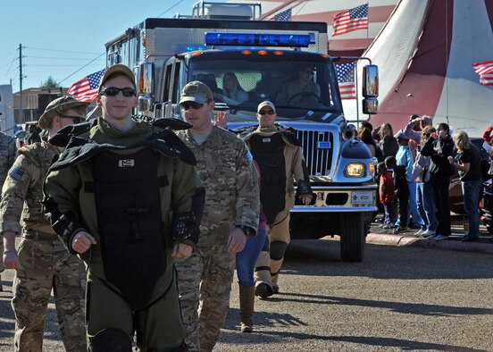 Explosive ordinance disposal Airmen from the 2nd Bomb Wing display their protective gear and other equipment while marching in the Veterans Parade at the State Fair of Louisiana in Shreveport, La., Nov. 8, 2015. Veterans Day is a national holiday held on Nov. 11 to honor military members past and present. (U.S. Air Force photo/ Senior Airman Joseph Raatz)