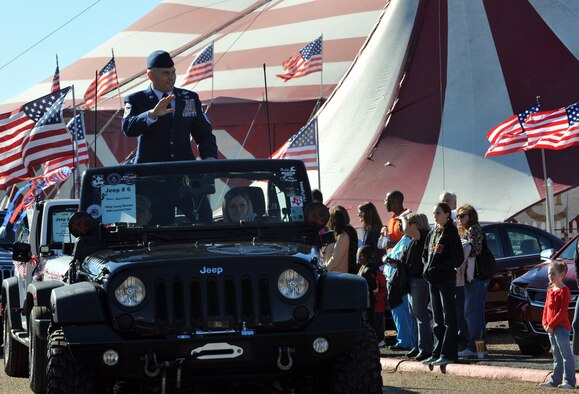 Chief Master Sgt. Tommy Mazzone, 2nd Bomb Wing command chief master sergeant, waves to a cheering bystander during the Veterans Parade at the State Fair of Louisiana in Shreveport, La., Nov. 8, 2015. President Eisenhower declared Nov. 11 a day of celebration to honor America's veterans for patriotism, love of country, willingness to serve and sacrifice for the common good. (U.S. Air Force photo/ Senior Airman Joseph Raatz)