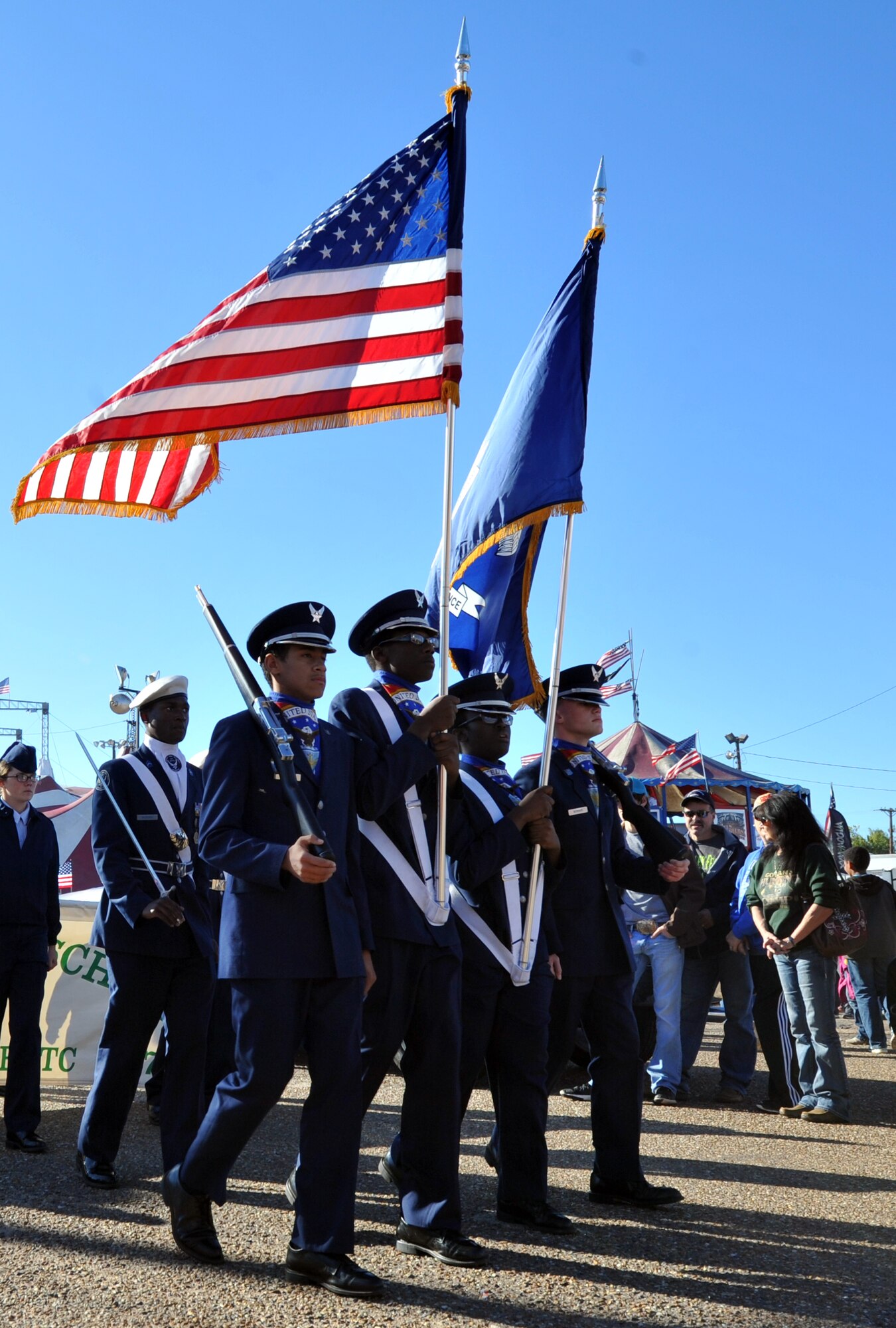 Junior Reserve Officers’ Training Corps cadets from Bossier High School march with the American and state of Louisiana flags during the Veterans Parade at State Fair of Louisiana in Shreveport, La., Nov. 8, 2015. Bossier High cadets joined JROTC cadets from all over the Shreveport-Bossier area to pay their respects to veterans by marching in formation with them during the parade. (U.S. Air Force photo/ Senior Airman Joseph Raatz)