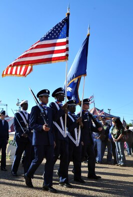 Junior Reserve Officers’ Training Corps cadets from Bossier High School march with the American and state of Louisiana flags during the Veterans Parade at State Fair of Louisiana in Shreveport, La., Nov. 8, 2015. Bossier High cadets joined JROTC cadets from all over the Shreveport-Bossier area to pay their respects to veterans by marching in formation with them during the parade. (U.S. Air Force photo/ Senior Airman Joseph Raatz)