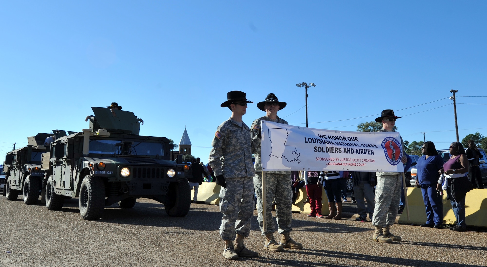 Louisiana Army National Guard Soldiers march with their High Mobility Multipurpose Wheeled Vehicles, or humvees, during the Veterans Parade at State Fair of Louisiana in Shreveport, La., Nov. 8, 2015. The humvee is an all-wheel drive military automobile designed primarily for personnel and light cargo transport. (U.S. Air Force photo/ Senior Airman Joseph Raatz)