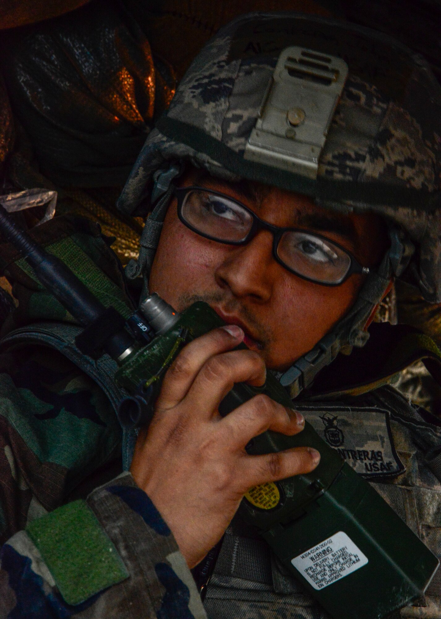 Airman 1st Class John Contreras, 51st Security Forces Squadron, radios for backup during an attack by opposing forces participating in readiness exercise Vigilant Ace 16 on Osan Air Base, Republic of Korea, Nov. 4, 2015. Scenarios for the ORE included aircraft accidents, medical emergencies, fires and chemical and missile attacks. The defenders utilized Vigilant Ace 16 as training in the event of real-world contingencies. (U.S. Air Force photo/Senior Airman Kristin High)
