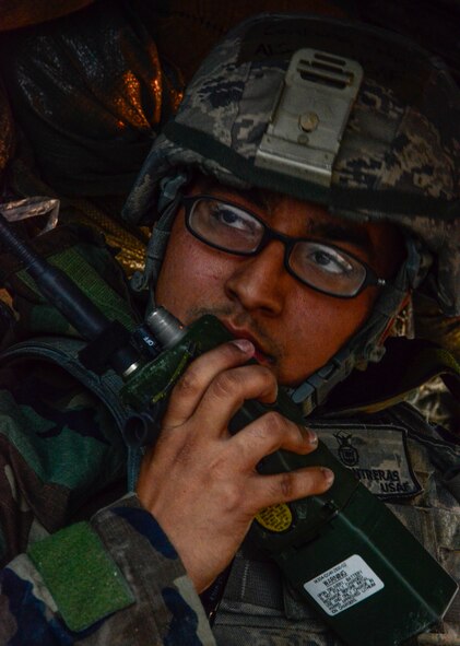 Airman 1st Class John Contreras, 51st Security Forces Squadron, radios for backup during an attack by opposing forces participating in readiness exercise Vigilant Ace 16 on Osan Air Base, Republic of Korea, Nov. 4, 2015. Scenarios for the ORE included aircraft accidents, medical emergencies, fires and chemical and missile attacks. The defenders utilized Vigilant Ace 16 as training in the event of real-world contingencies. (U.S. Air Force photo/Senior Airman Kristin High)