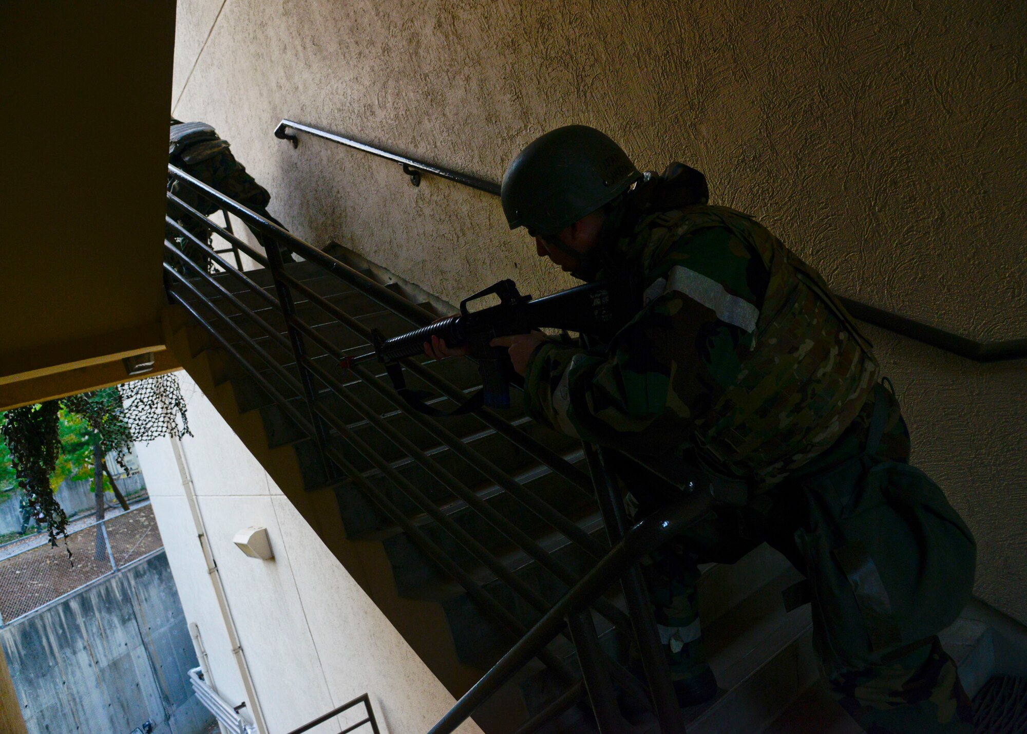 Defenders from the 51st Security Forces Squadron guard a building perimeter from opposing forces throughout a simulated attack during readiness exercise Vigilant Ace 16, on Osan Air Base, Republic of Korea, Nov. 4, 2015. The exercise gave defenders an opportunity to train for real-world contingencies using various scenarios. (U.S. Air Force photo/Senior Airman Kristin High)