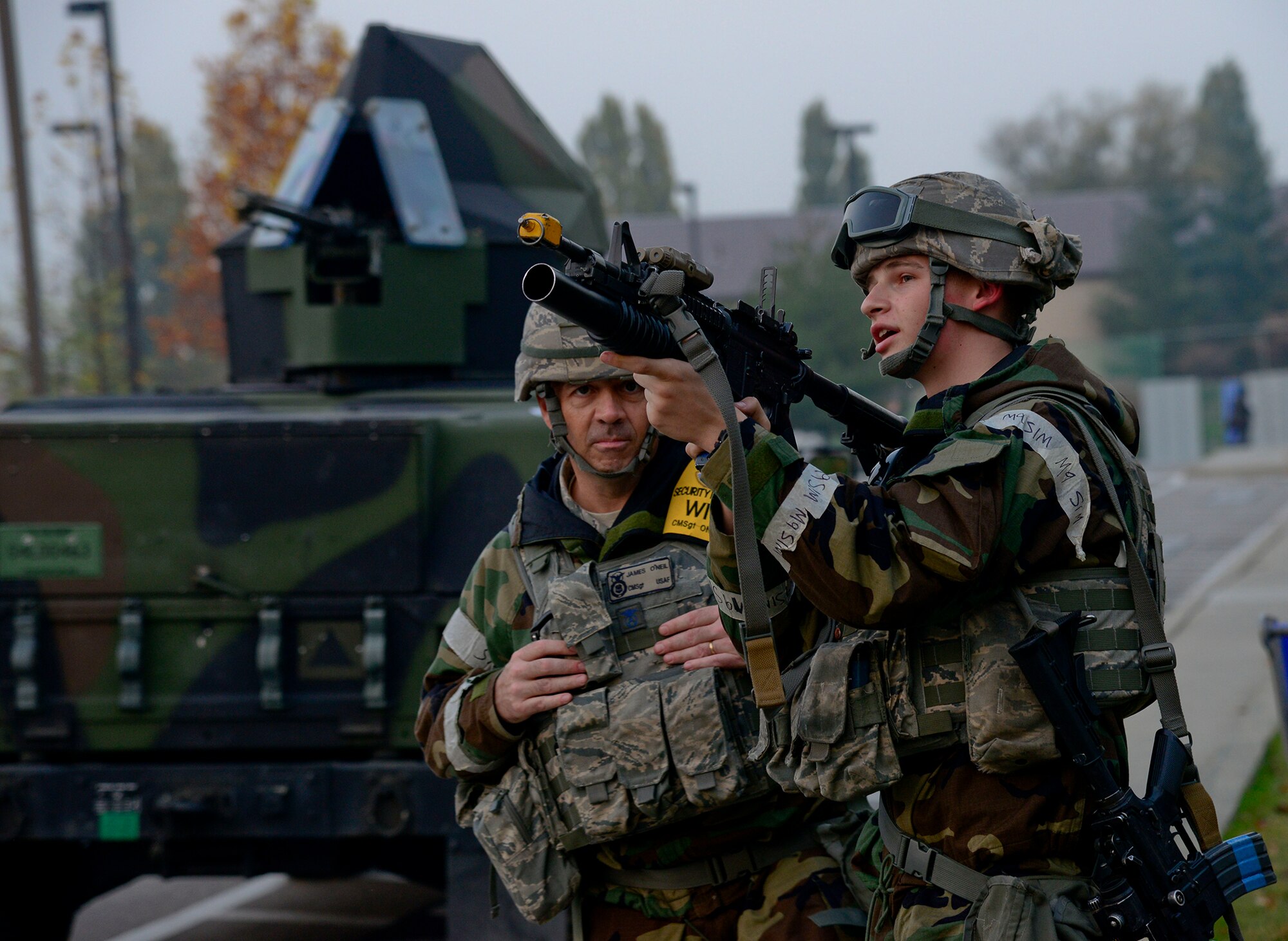 Airman Bradley Maier, 51st Security Forces Squadron, demonstrates using an M203 grenade launcher to Chief Master Sgt. James O???Neil, 51st Security Forces Squadron wing inspection team chief, during readiness exercise Vigilant Ace 16, on Osan Air Base, Republic of Korea, Nov. 4, 2015. After simulated opposing forces attacks, the WIT members asked strategic questions to ensure Airmen were retaining knowledge and understanding scenarios. (U.S. Air Force photo/Senior Airman Kristin High)