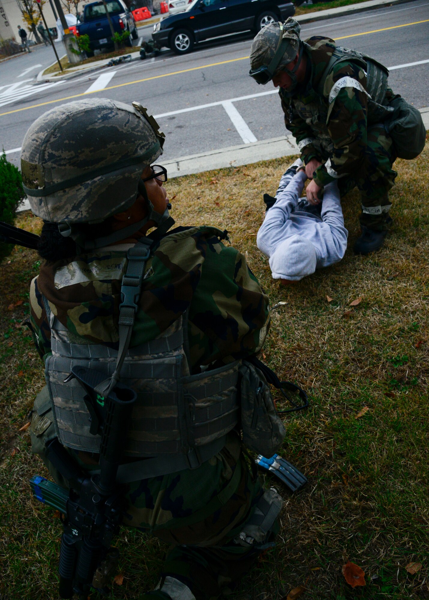 Staff Sgt. Jasmine Wilkerson, 51st Security Forces Squadron, watches for additional opposing forces as another member is detained during a simulated readiness exercise Vigilant Ace 16 attack, on Osan Air Base, Republic of Korea, Nov. 4, 2015. Various scenarios were practiced throughout the week to provide defenders an opportunity to learn in a stressful environment while honing important survival tactics. (U.S. Air Force photo/Senior Airman Kristin High)