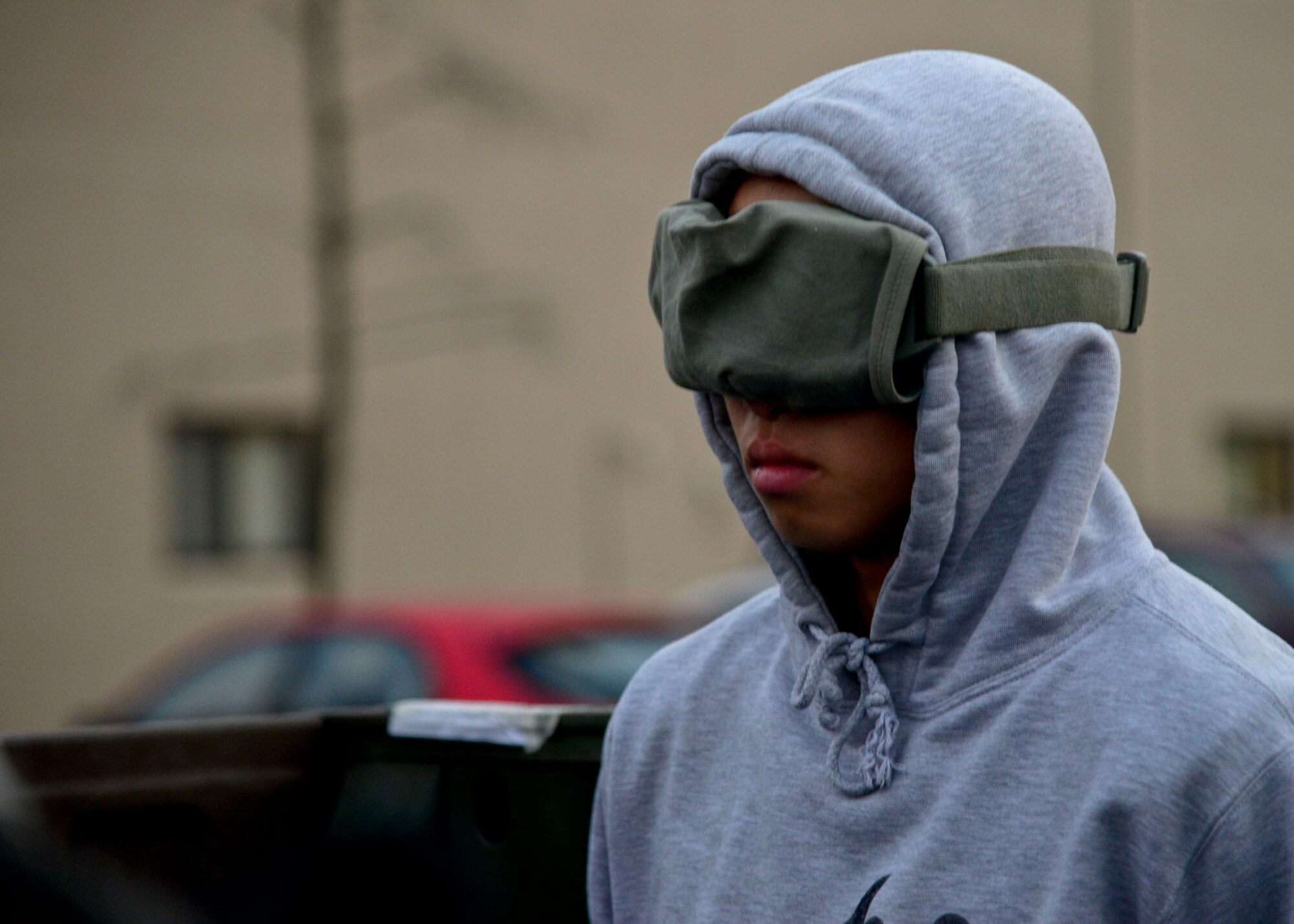 Airman Gun Pak, 51st Security Forces Squadron Defender, is detained during readiness exercise Vigilant Ace 16, on Osan Air Base, Republic of Korea, Nov. 4, 2015. To ensure the detainees do not have knowledge of their surroundings, they are blindfolded while escorted to jail. Throughout the exercise, defenders used Team Osan Airmen and augmentees from the 35th SFS, Misawa Air Base, Japan, as opposing forces to simulate real-world conditions. (U.S. Air Force photo/Senior Airman Kristin High)