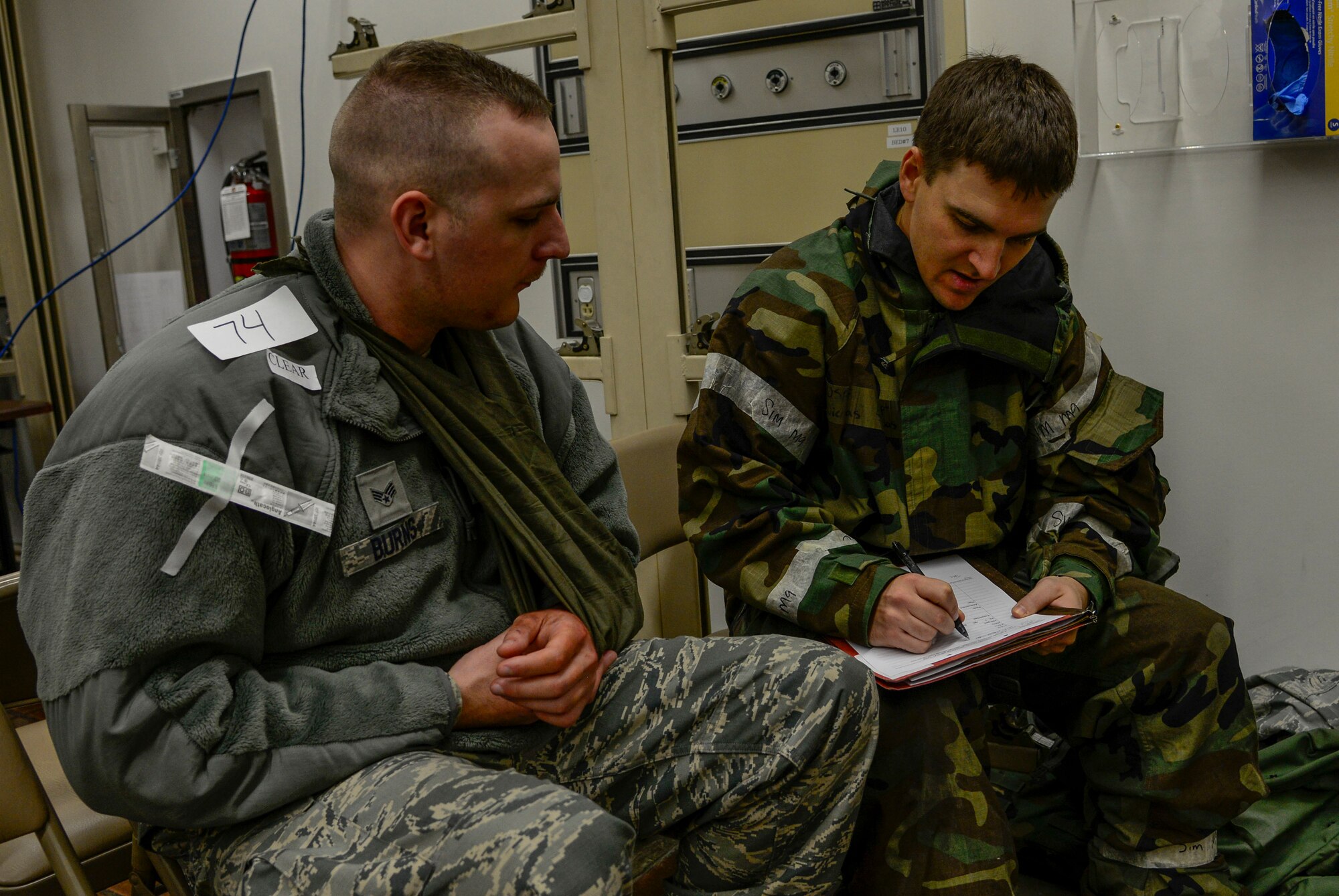 Capt. Nicolas Skordas, right, 51st Medical Operations Squadron orthopedic surgeon, checks vitals on Senior Airman Nicholas Burns, 51st Dental Squadron prophylactics technician, during readiness exercise Vigilant Ace 16 on Osan Air Base, Republic of Korea, Nov. 3, 2015. The simulation was part of the peninsula-wide exercise, challenging U.S. and ROK forces in multiple conditions, including various mild to severe injuries requiring medical air evacuation. (U.S. Air Force photo/Senior Airman Kristin High)
