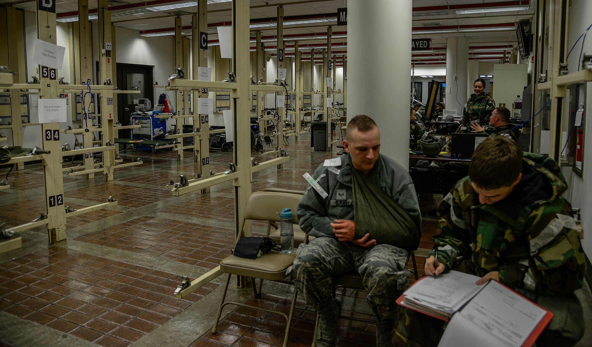 Capt. Nicolas Skordas, right, 51st Medical Operations Squadron orthopedic surgeon, checks vitals on Senior Airman Nicholas Burns, 51st Dental Squadron prophylactics technician, during readiness exercise Vigilant Ace 16 on Osan Air Base, Republic of Korea, Nov. 3, 2015. The triage area can hold more than 150 patients on medical litters. (U.S. Air Force photo/Senior Airman Kristin High)