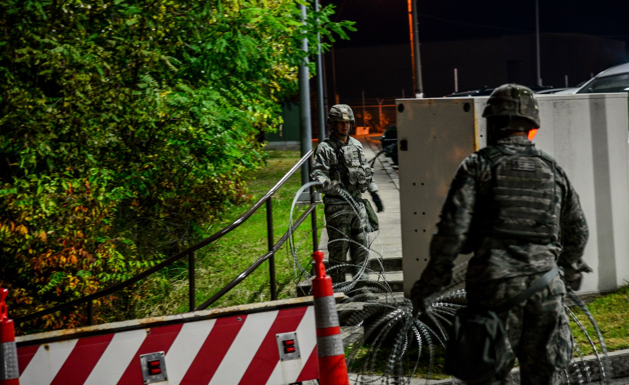 Security forces members from the 51st Fighter Wing lay out concertina wire around a strategic point on Osan Air Base, Republic of Korea, Nov. 2, 2015, during Vigilant Ace 16. The razor laden wire is used during exercises to help cordon off areas from foot and light vehicle traffic. More than 16,000 U.S. personnel will participate in Vigilant Ace 16, an exercise designed to enhance interoperability between U.S. and Republic of Korea forces and increase the combat effectiveness of both nations. (U.S. Air Force photo/Tech. Sgt. Travis Edwards)