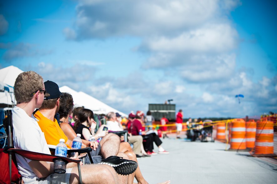 Spectators watch as the U.S. Air Force Academy Wings of Blue Parachute Team during Thunder Over South Georgia Open House Nov. 7, 2015, at Moody Air Force Base, Ga. More than 700 cadets are given an opportunity to earn their wings with the Wings of Blue. (U.S. Air Force photo by Senior Airman Olivia Dominique/Released)