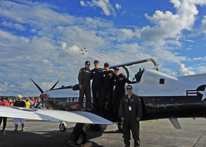 Pilots from Columbus Air Force Base, Mississippi, and members of the U.S. Air Force Parachute Team pause for a photo during the Thunder over South Georgia Open House Nov. 7 at Moody Air Force Base, Ga. Along with various aerial performances, the Open House featured static displays of many U.S. Air Force aircraft. (U.S. Air Force photo/Senior Airman Stephanie Englar)
