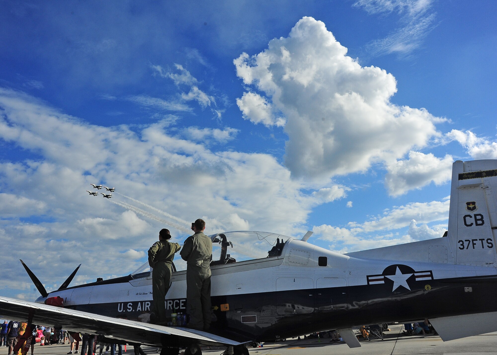 The Thunderbirds fly over a T-6 Texan II and two pilots from Columbus Air Force Base, Mississippi during the Thunder Over South Georgia Open House Nov. 7 at Moody Air Force Base, Ga. Pilots from Columbus AFB brought in the T-6 Texan II, the T-1A Jayhawk and the T-38C Talon for the audience to view during the open house. (U.S. Air Force photo/Senior Airman Stephanie Englar)