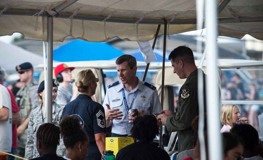U.S. Air Force Chief Master Sgt. Candace Smith, USAF Thunderbirds Chief Enlisted Manager, speaks to Col. Thomas Kunkel, 23d Wing commander, and Capt. James Schmidt, 23d WG executive officer, during the Thunder Over South Georgia Open House, Nov. 7, 2015, at Moody Air Force Base, Ga. The open house is an opportunity for Moody to thank the local community for all its support, and exhibit air power. (U.S. Air Force photo by Senior Airman Olivia Dominique/Released)