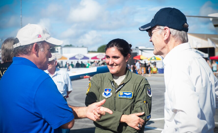 U.S. Air Force 1Lt. Karen Rubin-Santos, 37th Flying Training Squadron, speaks to two retirees during the Thunder Over South Georgia Open House, Nov. 7, 2015, at Moody Air Force Base, Ga. The Open House is an opportunity for Moody to thank the local community for all its support. (U.S. Air Force photo by Senior Airman Olivia Dominique/Released)