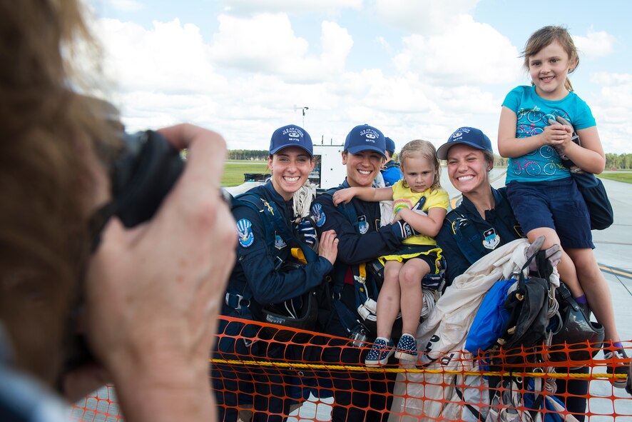 Visitors pose with members of the U.S. Air Force Academy Wings of Blue Parachute Team during the Thunder Over South Georgia Open House, Nov. 7, 2015, at Moody Air Force Base, Ga. The Wings of Blue are a demonstration team that represents the Air Force in precision parachuting. (U.S. Air Force photo by Senior Airman Ceaira Tinsley/Released)