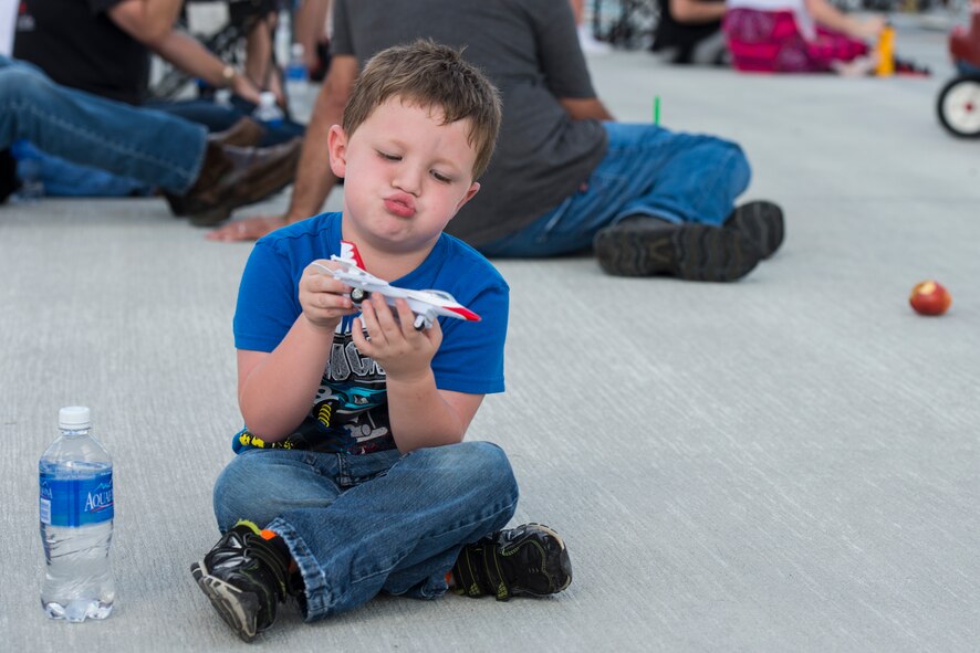 Brian, son of Kaitlin King, maneuvers his model F-16C Fighting Falcon during the Thunder Over South Georgia Open House, Nov. 7, 2015, at Moody Air Force Base, Ga. Brian attended his first open house and viewed the Thunderbirds performing an aerial demonstration. (U.S. Air Force photo by Senior Airman Ceaira Tinsley/Released)