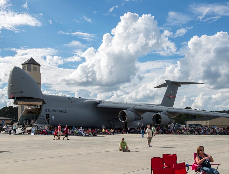 Attendees of Thunder Over South Georgia take shelter from the sun under a C-5 Galaxy, Nov. 7, 2015 at Moody Air Force Base, Ga. Guests in attendance found creative ways to stay cool by using wet towels, umbrellas and sitting underneath shaded areas. (U.S. Air Force photo/Tech. Sgt. Zachary Wolf)