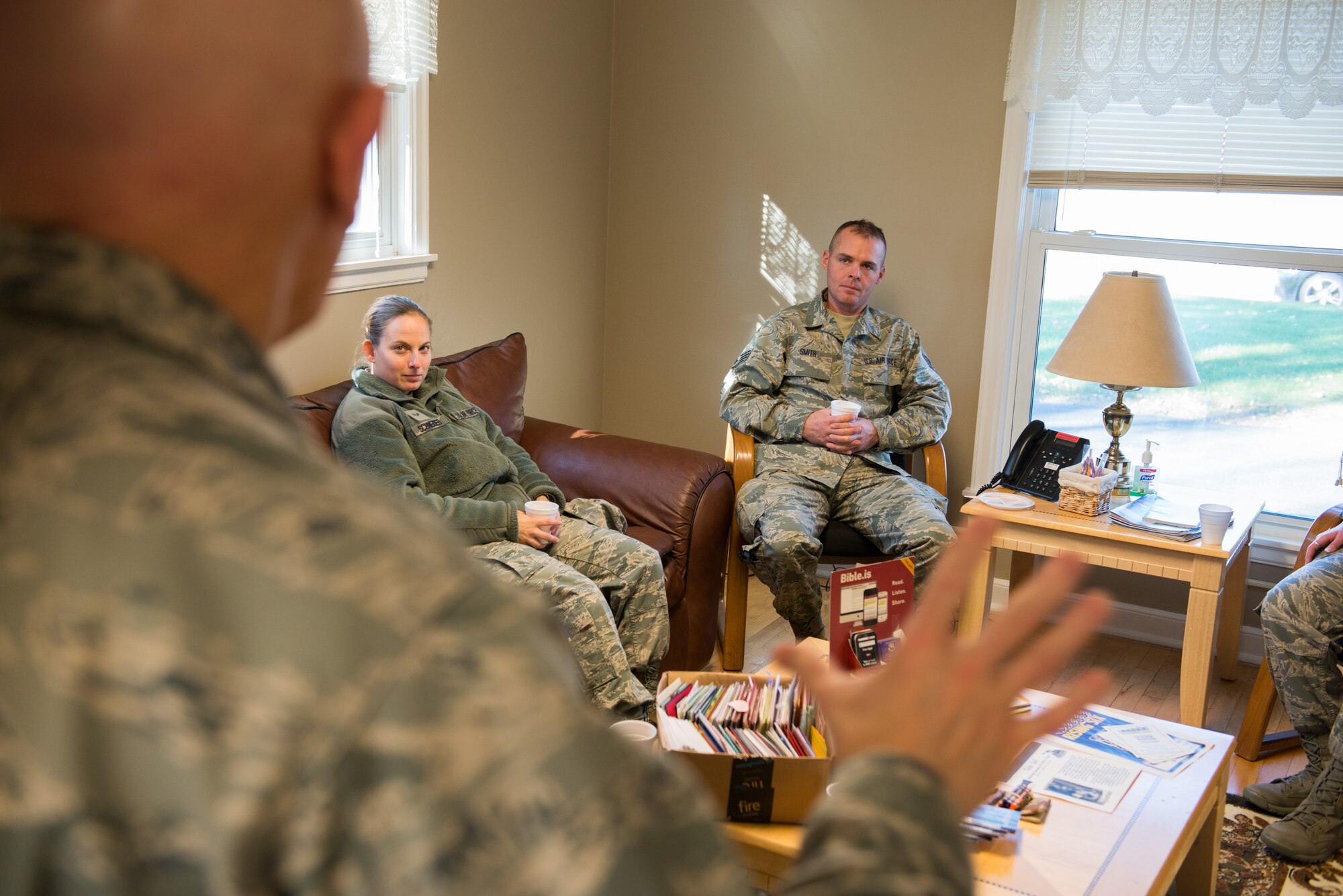 Chaplain Lawrence Blake speaks to 27th Aerial Port members Senior Airman Amber Schneider, left, and Staff Sgt. Eli at the Chapel/Honor Guard social on Nov. 8. (U.S. Air Force photo by Staff Sgt. Trevor Saylor)