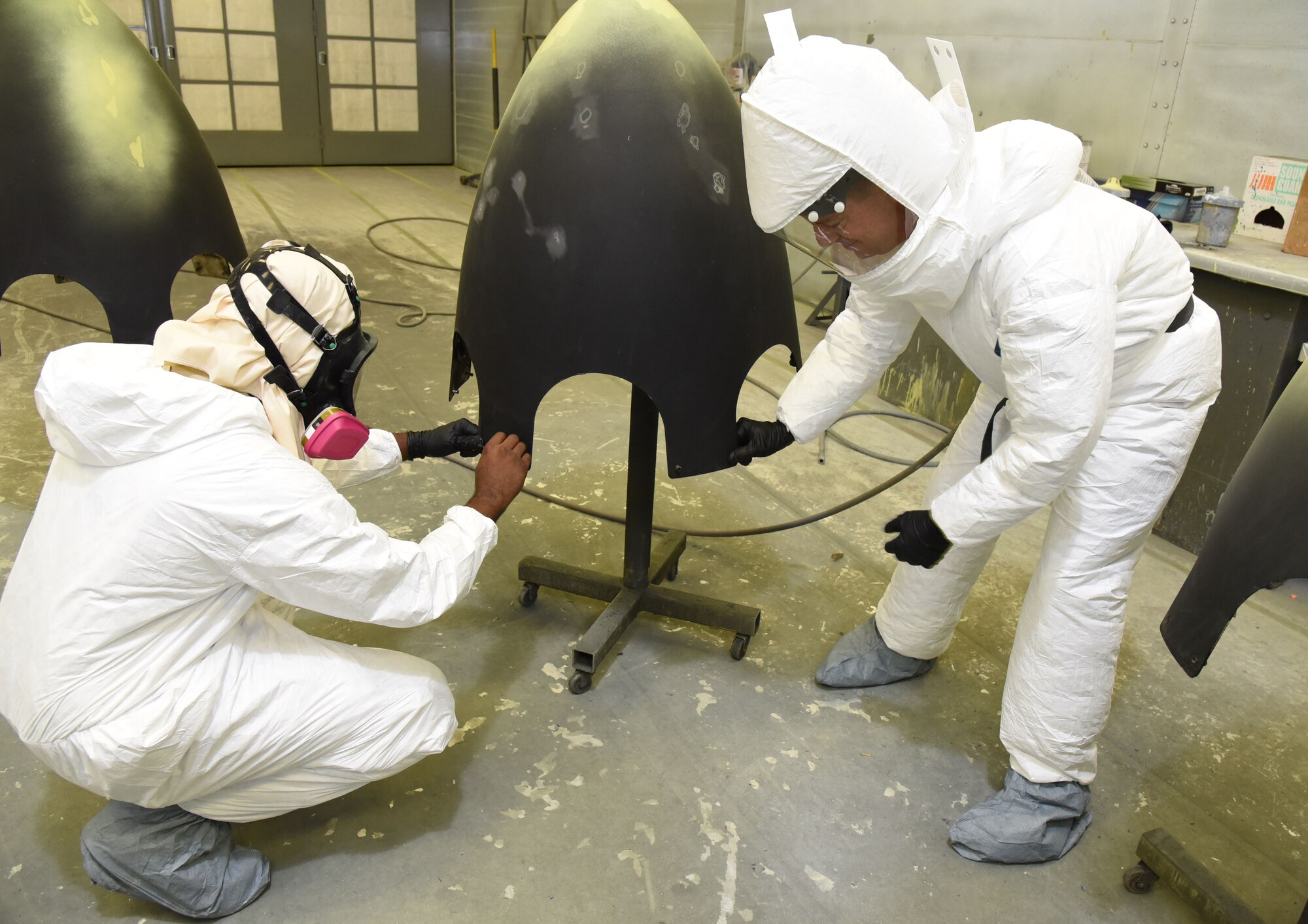 Col. Frank Amodeo (right), 403rd Wing commander, and Senior Airman Joshua Nichols, 403rd Fabrication Flight aircraft sheet metal mechanic/painter, prepare a C-130J prop spinner for a new paint job at the 403rd Wing fabrication shop at Keesler Air Force Base, Mississippi, Nov. 8, 2015. The colonel works alongside other wing reservists during unit training assemblies as much as possible to gain a better perspective of the various jobs performed by the wing's Citizen Airmen. (U.S. Air Force photo/Tech. Sgt. Ryan Labadens)