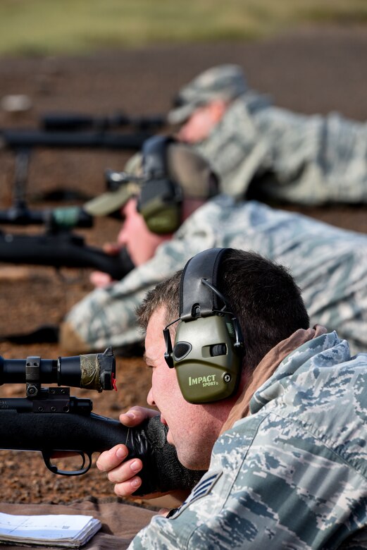 Members of the 188th Security Forces Squadron ready their weapons during known distance sniper and advanced designated marksman qualification Nov. 6, 2015 at Fort Chaffee Joint Maneuver Training Center, Ark. 188th SFS members qualified on the M-24 rifle at designated distances of 100, 300, 400 and 500 yards and with moving targets to maintain combat readiness and efficiency as marksmen. (U.S. Air National Guard photo by Capt. Holli Nelson)