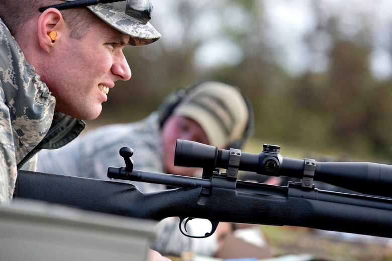 Senior Airman Christopher Kleist, of the 188th Security Forces Squadron, looks down the range over his M-24 rifle Nov. 6, 2015 during known distance sniper and advanced designated marksman qualification at Fort Chaffee Joint Maneuver Training Center, Ark. The 188th SFS maintains combat readiness and efficiency through annual training on their designated weapons systems which allows them to remain proficient as marksmen. The training consisted of qualifications at 100, 300, 400, and 500 yards and with moving targets at designated distances. (U.S. Air National Guard photo by Capt. Holli Nelson)