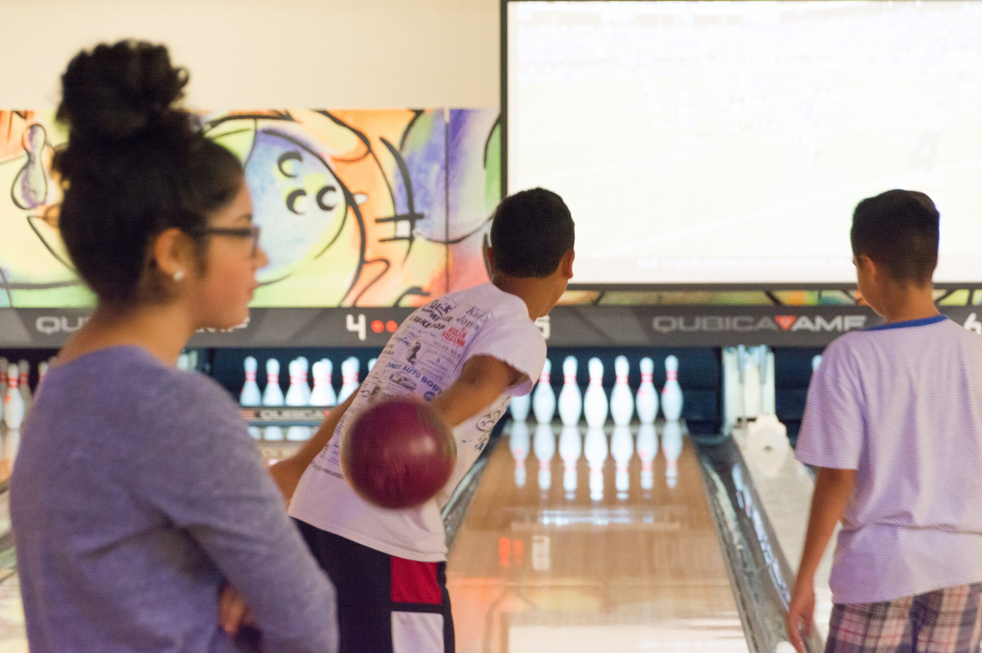NAVAL AIR STATION FORT WORTH JOINT RESERVE BASE, Texas - Elie Chavez (left), Air Force Reserve Command Teen Leadership Council member, waits for a fellow teen to finish bowling during the 301st Fighter Wing Teen Bowling Party here, Oct. 3, 2015. Chavez coordinated the party to connect teens of military families to one another and spread awareness of the many benefits available to them. (U.S. Air Force photo/Staff Sgt. Samantha Mathison)