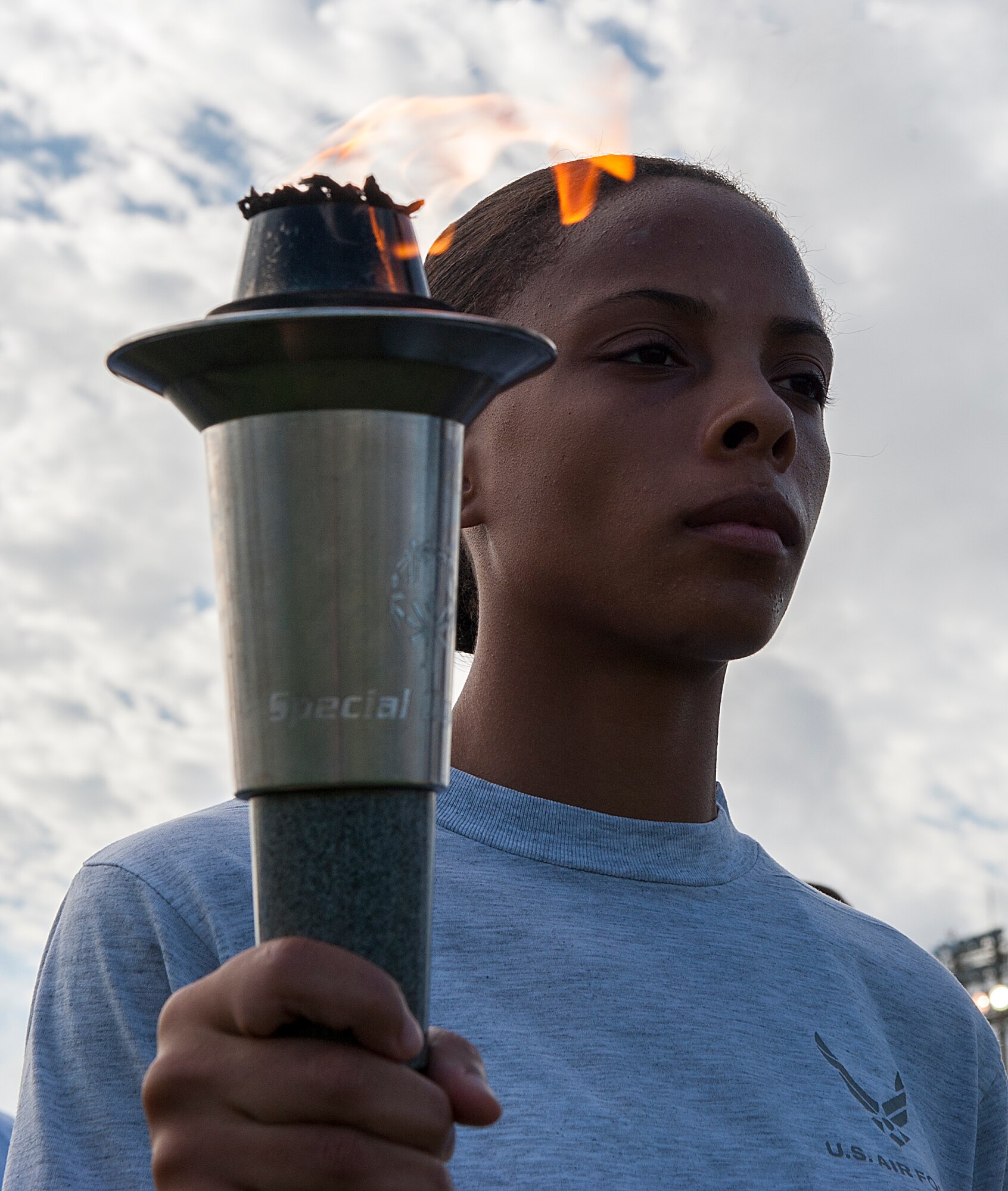 U.S. Air Force Staff Sgt. Ashley Hodge, 18th Security Forces Squadron criminal investigator, holds a torch during the Kadena Special Olympics Torch Run Nov. 6, 2015, at Kadena Air Base, Japan. This year marks the 16th anniversary of KSO, a sporting event dedicated to enriching the lives of American and Okinawan special needs individuals on the island. (U.S. Air Force photo by Airman 1st Class Corey M. Pettis)