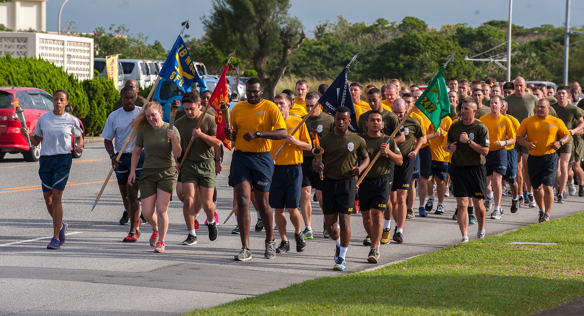 Each U.S. military branch runs with an olympic torch in honor of the Kadena Special Olympics Nov. 6, 2015, at Kadena Air Base, Japan. Established by the 18th Wing commander in 2000, KSO is a sporting and entertainment event that provides an opportunity for all communities involved to stand together in support of people with special needs. (U.S. Air Force photo by Airman 1st Class Corey M. Pettis)