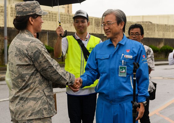 U.S. Air Force Col. Debra Lovette, 18th Mission Support Group commander, shakes hands with Kamiyama Masakatsu, Chatan Town deputy mayor Nov. 5, 2015, at Kadena Air Base, Japan. The two greeted residents of Chatan Town who were participating in a bilateral tsunami evacuation. The exercise was organized in support of an agreement made last year that opens Kadena's gates to the local population in the event of a natural disaster. (U.S. Air Force photo by Senior Airman John Linzmeier)
