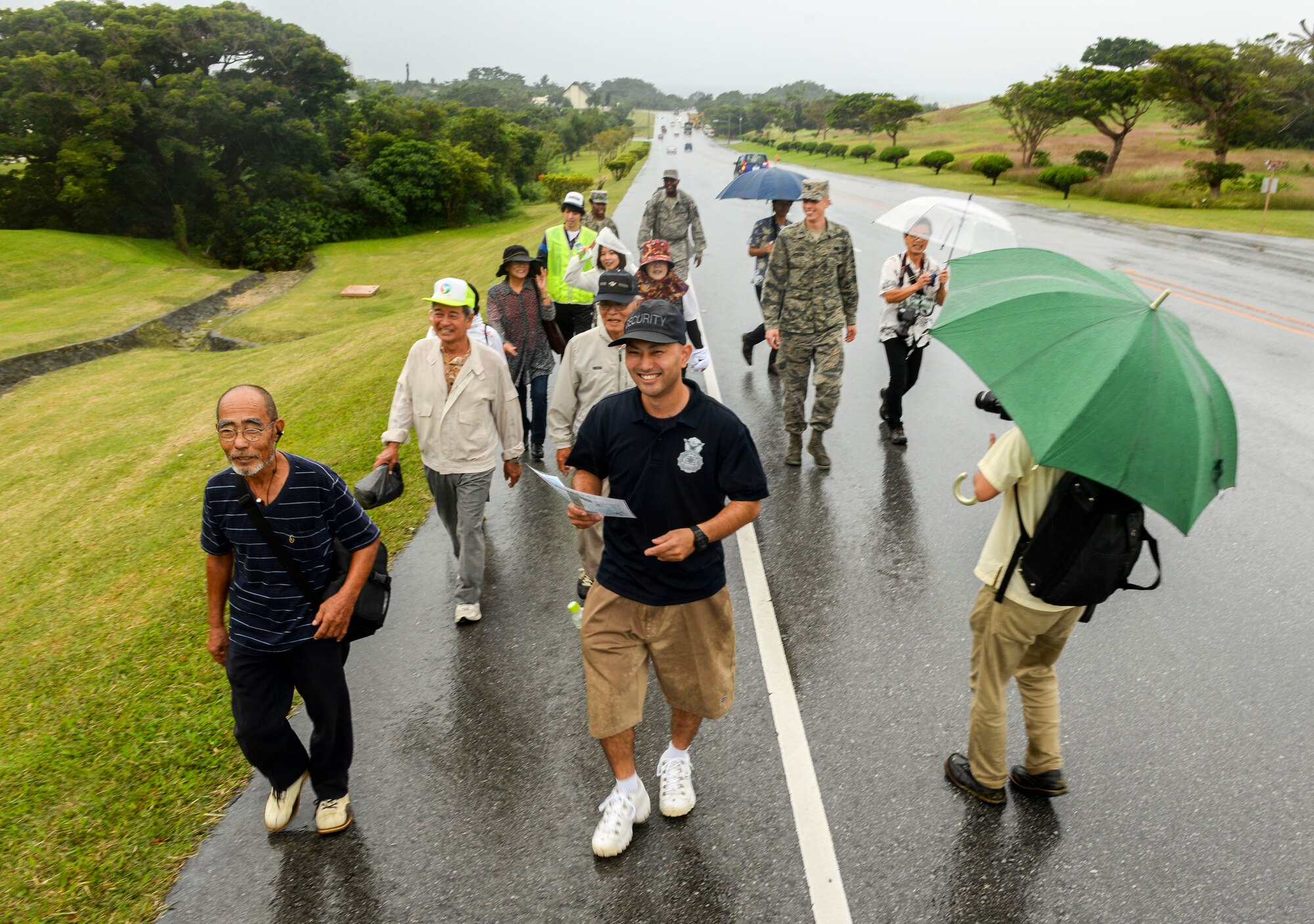 Residents of Chatan Town follow Teruya Youhei, 18th Security Forces Squadron civilian guard, to higher ground during a bilateral tsunami exercise Nov. 5, 2015, at Kadena Air Base, Japan. The exercise entailed the evacuation of local Okinawans from low elevation areas near the Sunabe Seawall to higher ground on base. (U.S. Air Force photo by Senior Airman John Linzmeier)