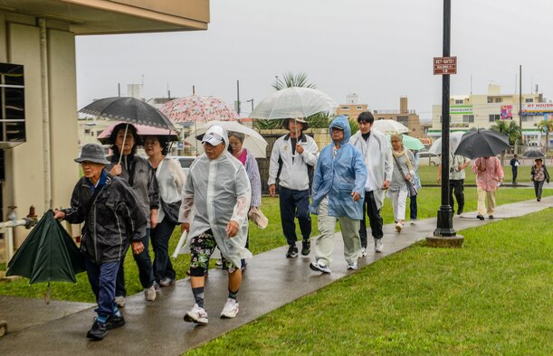 Residents of Chatan Town make their way to the entrance of Kadena Air Base, Japan, as part of a bilateral tsunami exercise Nov. 5, 2015. Security Forces personnel provided gate entry to all participants and provided escorts as the locals made their way to a designated recovery zone. (U.S. Air Force photo by Senior Airman John Linzmeier)