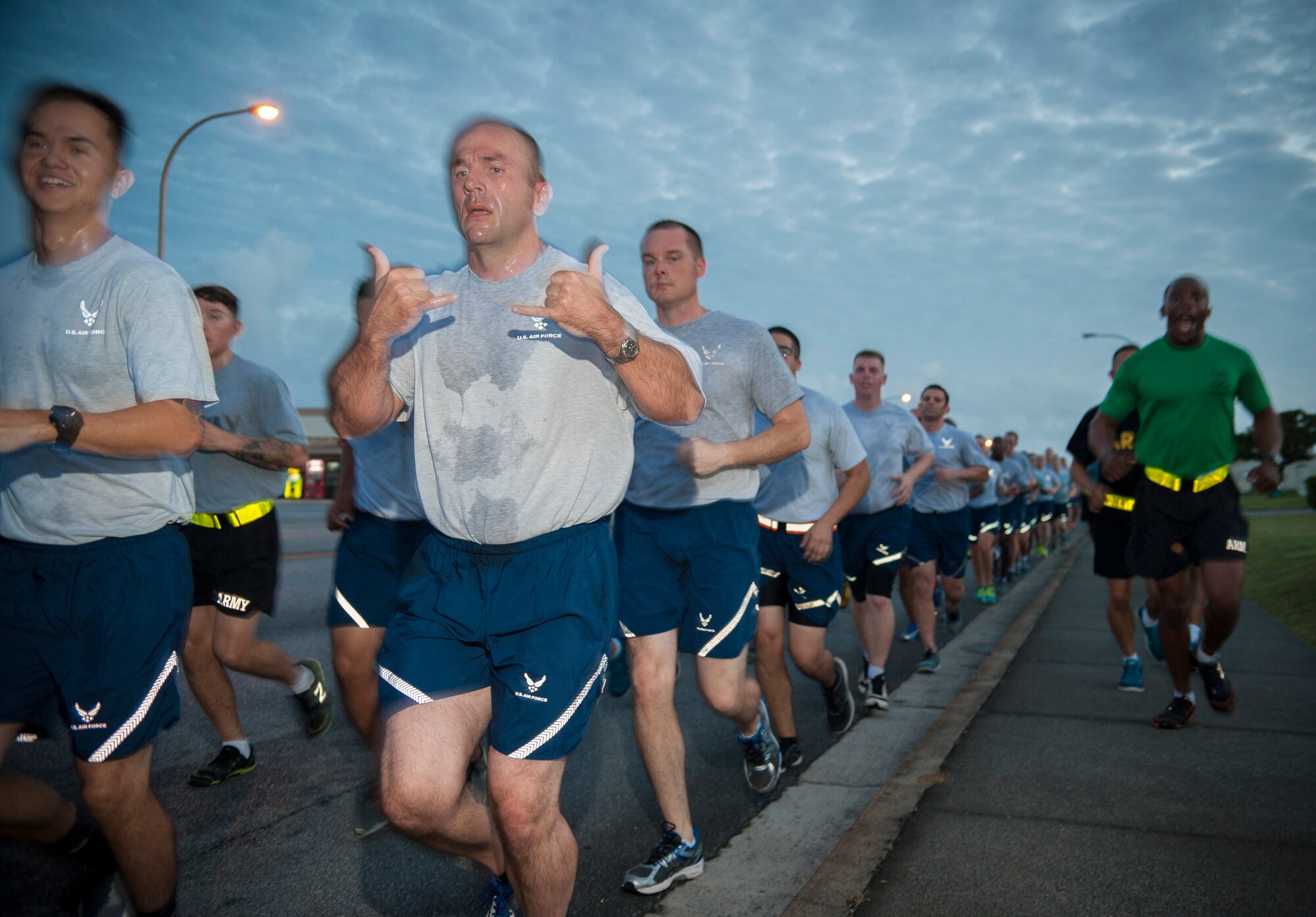 Airmen and Soldiers run together during an Army/Air Force 5K run Nov. 6, 2015, at Kadena Air Base, Japan. The run was held as a means to strengthen the bond between sister services as members of Team Kadena. (U.S. Air Force photo by Master Sgt. Jason W. Edwards)