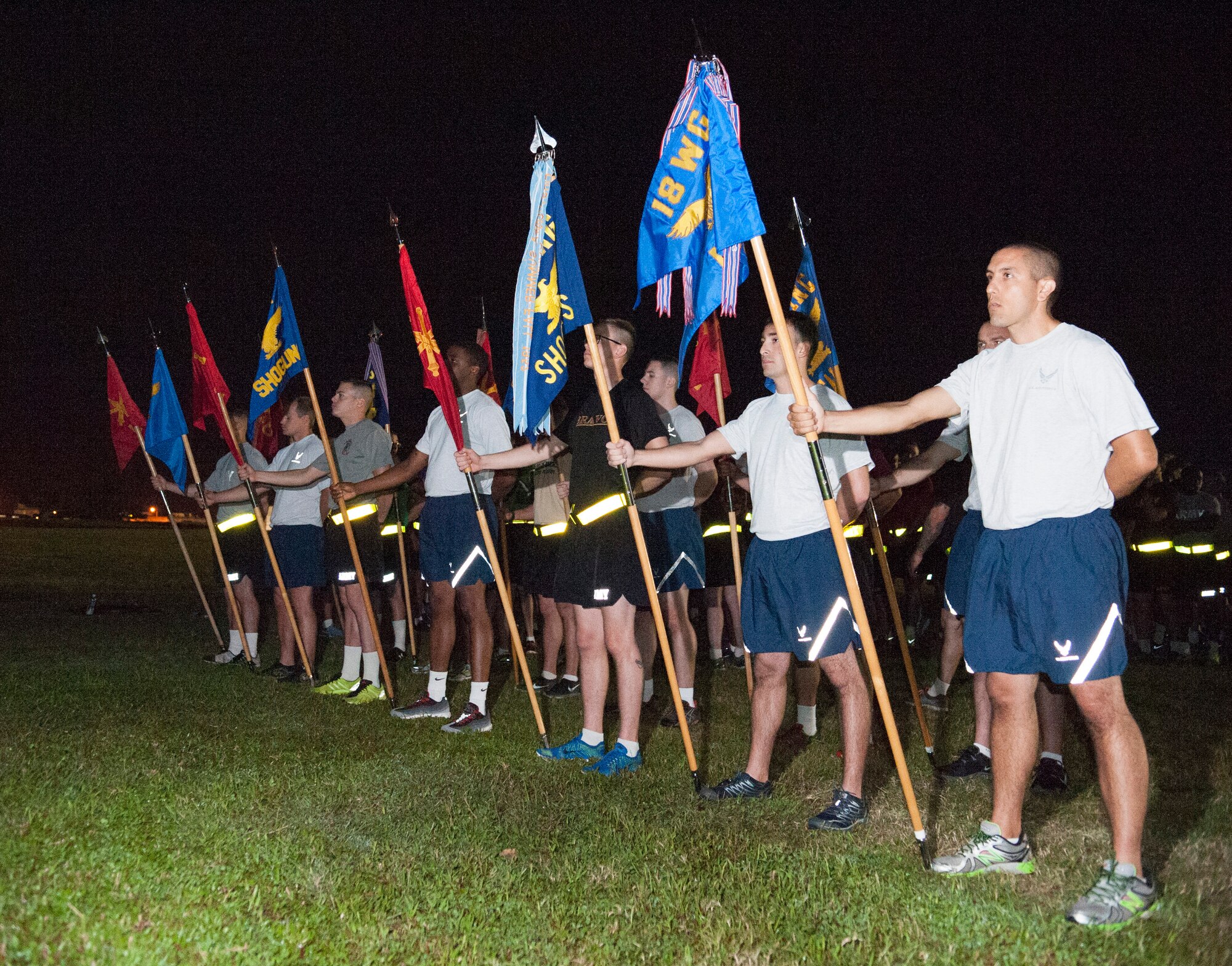 Army and Air Force members of Team Kadena display unit colors in formation prior to an Army/Air Force 5K run Nov. 6, 2015, at Kadena Air Base, Japan. The run signified strength and unity among Team Kadena's joint services. (U.S. Air Force photo by Master Sgt. Jason W. Edwards)