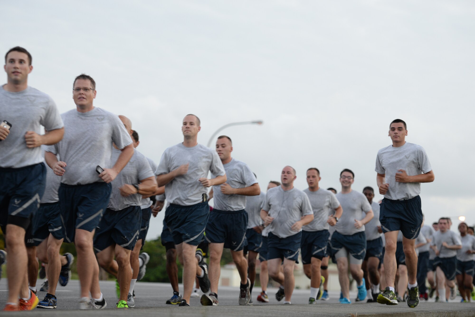 Airmen run together to show support to their sister service during an Army/Air Force 5K run Nov. 6, 2015, at Kadena Air Base, Japan. The run was held as a means to strengthen the bond between sister services as members of Team Kadena. (U.S. Air Force photo by Staff Sgt. Amber E. N. Jacobs)