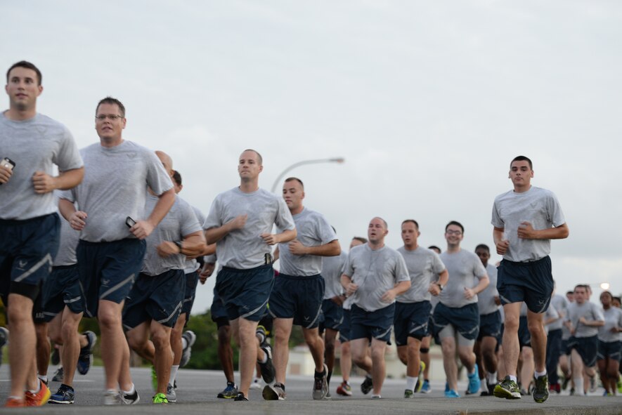 Airmen run together to show support to their sister service during an Army/Air Force 5K run Nov. 6, 2015, at Kadena Air Base, Japan. The run was held as a means to strengthen the bond between sister services as members of Team Kadena. (U.S. Air Force photo by Staff Sgt. Amber E. N. Jacobs)