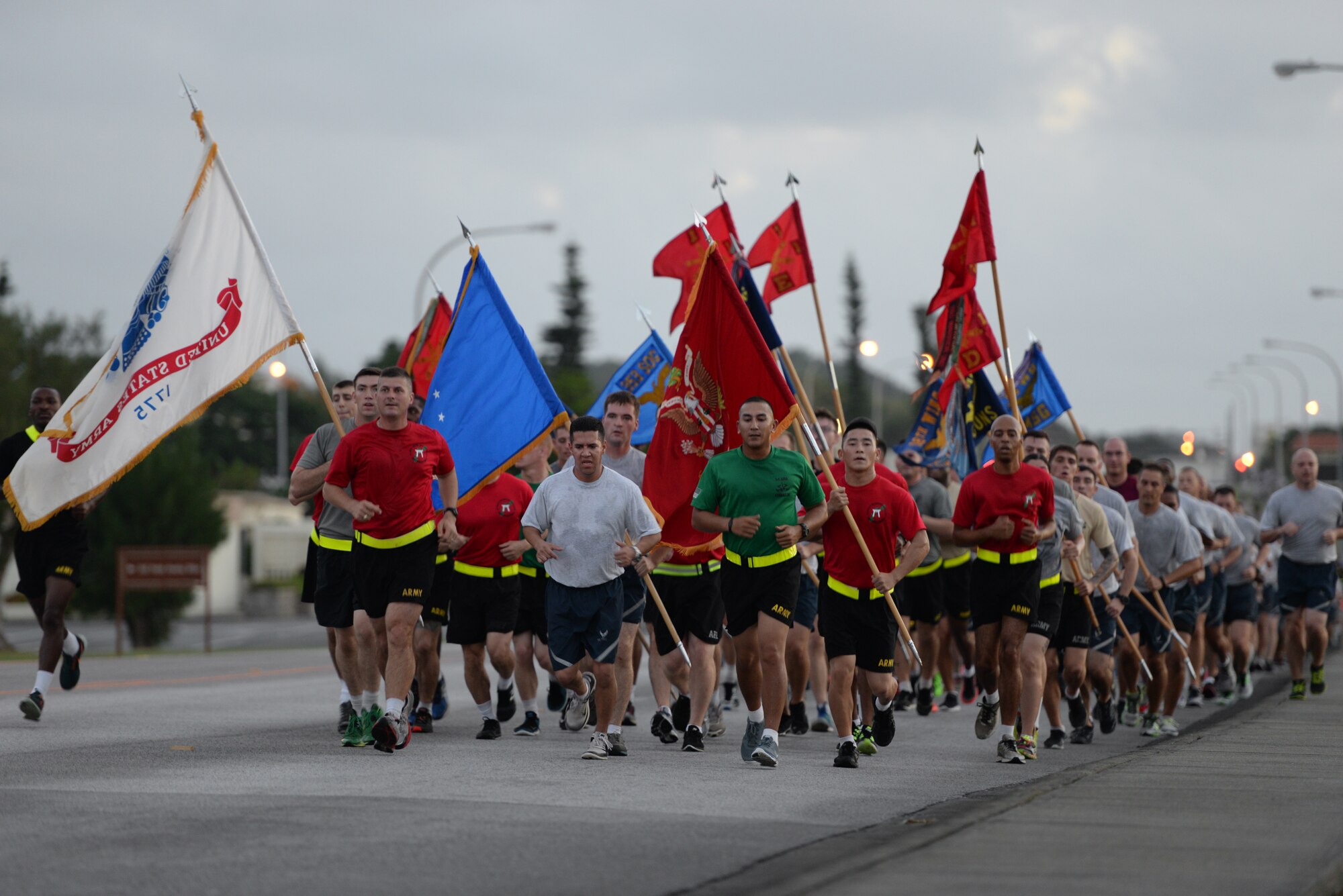 Army and Air Force members of Team Kadena display unit colors during an Army/Air Force 5K run Nov. 6, 2015, at Kadena Air Base, Japan. The run signified strength and unity among Team Kadena’s joint services. (U.S. Air Force photo by Staff Sgt. Amber E. N. Jacobs)