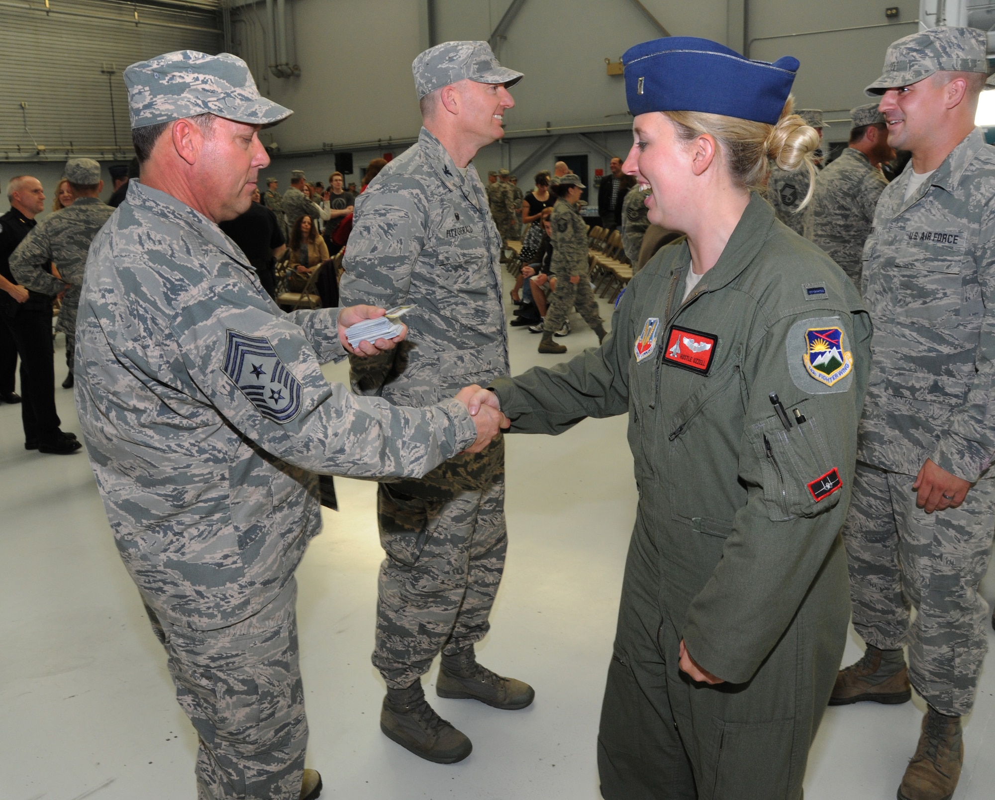 Oregon Air National Guard Chief Master Sgt. Andy Gauntz, Oregon State Command Chief, greets 1st Lt. Kimberly Uzzell, right, assigned to the 123rd Expeditionary Fighter Squadron, during the formal demobilization ceremony, Nov. 6, 2015, Portland Air National Guard Base, Ore. (U.S. Air National Guard photo by Tech. Sgt. John Hughel, 142nd Fighter Wing Public Affairs/Released)