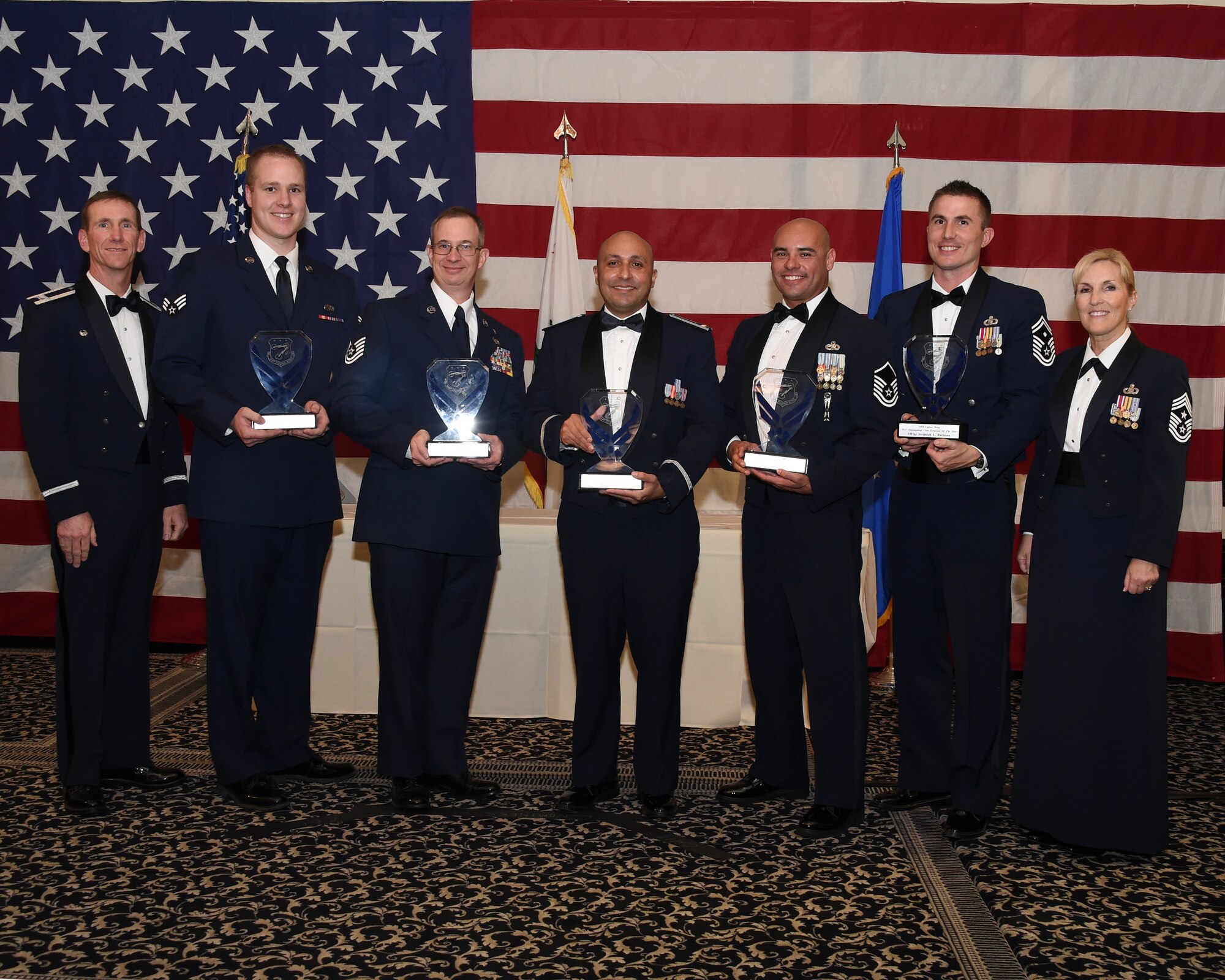 U.S. Air Force Col. Clay Garrison, far left, the commander of the 144th Fighter Wing and Chief Master Sgt. Linda Brown, far right, the 144th Fighter Wing command chief, recognize the 144th Fighter Wing Airmen of the Year. The 2015 winners of the Airmen of the Year are Senior Airman Andrew Cochran of the Maintanence Group, Tech. Sgt Gordon Pipes of the Mission Support Group, 2nd Lt. Max Montellano of the Mission Support Group, Master Sgt. Antonio Chacon of the Maintanence Group and First Sgt. Jeremiah Burleson of Fighter Wng Headquarters. U.S. Airmen attached to the California Air National Guard, 144th Fighter Wing, celebrate the Airmen of the Year, Nov. 7, 2015. (Air National Guard photo by Master Sgt. David J. Loeffler)