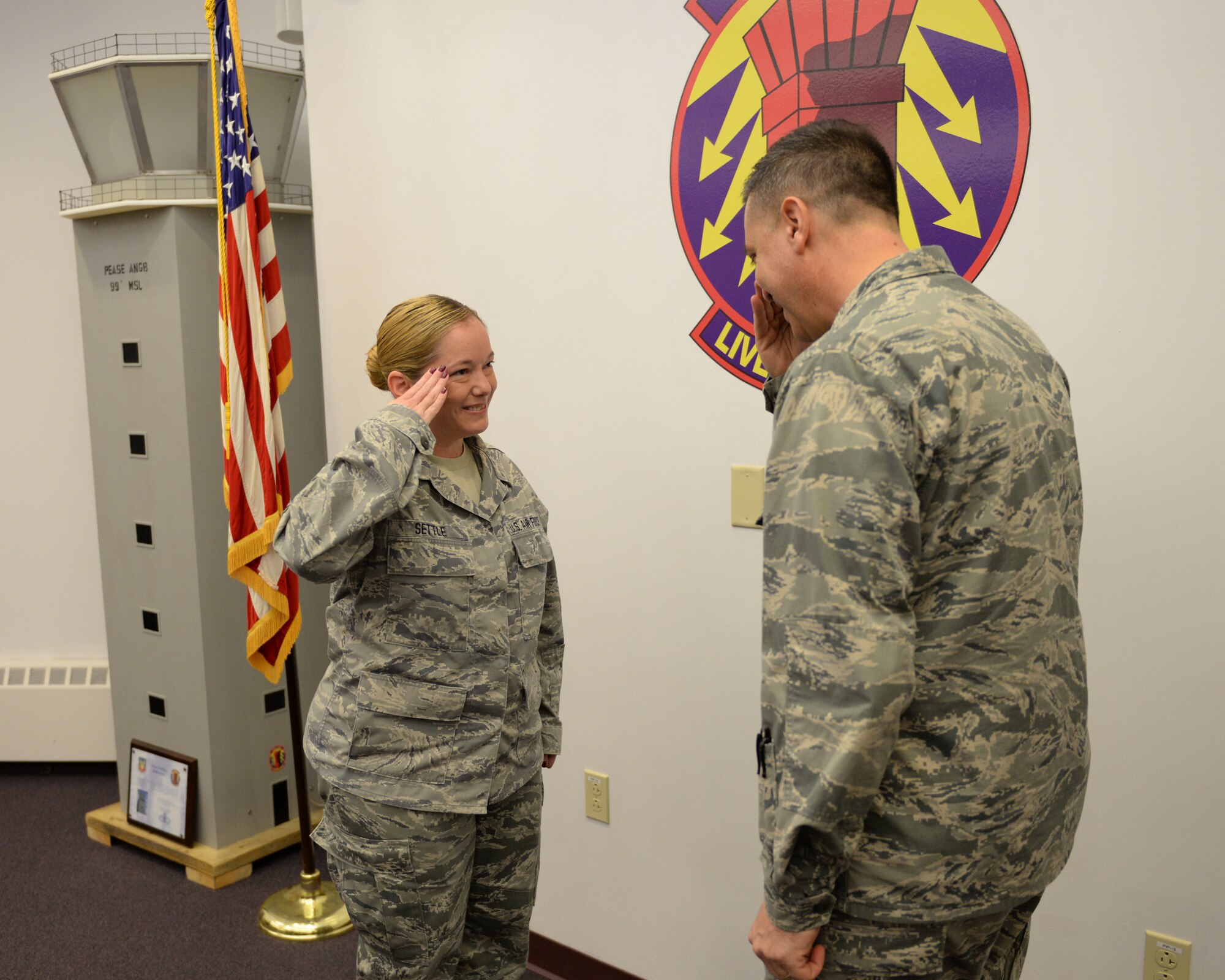 U.S. Air Force Brig. Gen. Michael. R. Taheri, commander Air National Guard Readiness Center at Joint Base Andrews, Maryland, salutes Master Sgt. Maria Settle after a coin presentation recognizing outstanding  Airmen at Pease Air National Guard Base, New Hampshire, Nov. 7, 2015.  (U.S. Air National Guard photo by Staff Sgt. Curtis J. Lenz)
