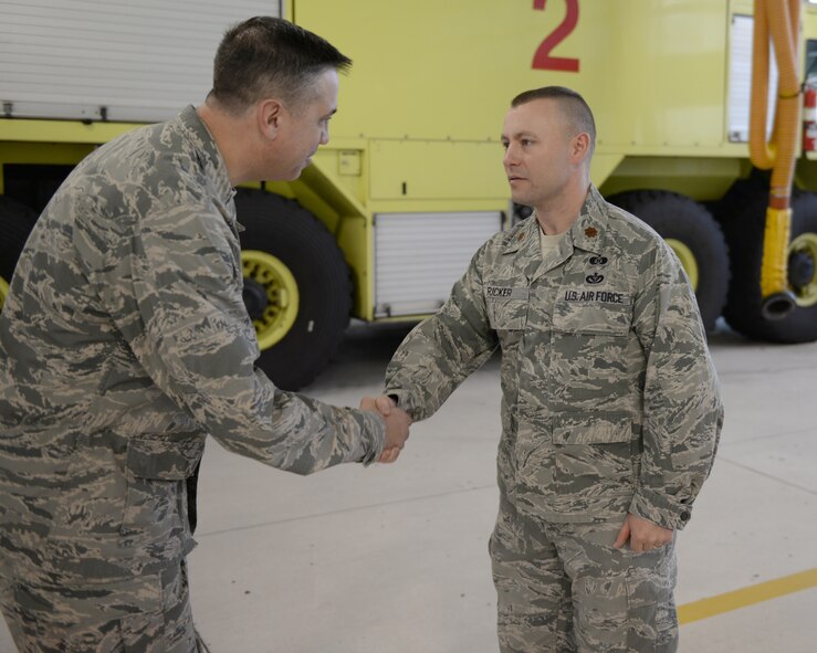 U.S. Air Force Brig. Gen. Michael. R. Taheri, left, commander Air National Guard Readiness Center at Joint Base Andrews, Maryland, shakes hands with Maj. Autumn Ricker after  a coin presentation recognizing outstanding Airmen, Pease Air National Guard Base, New Hampshire, Nov. 7, 2015. (U.S. Air National Guard photo by Staff Sgt. Curtis J. Lenz)